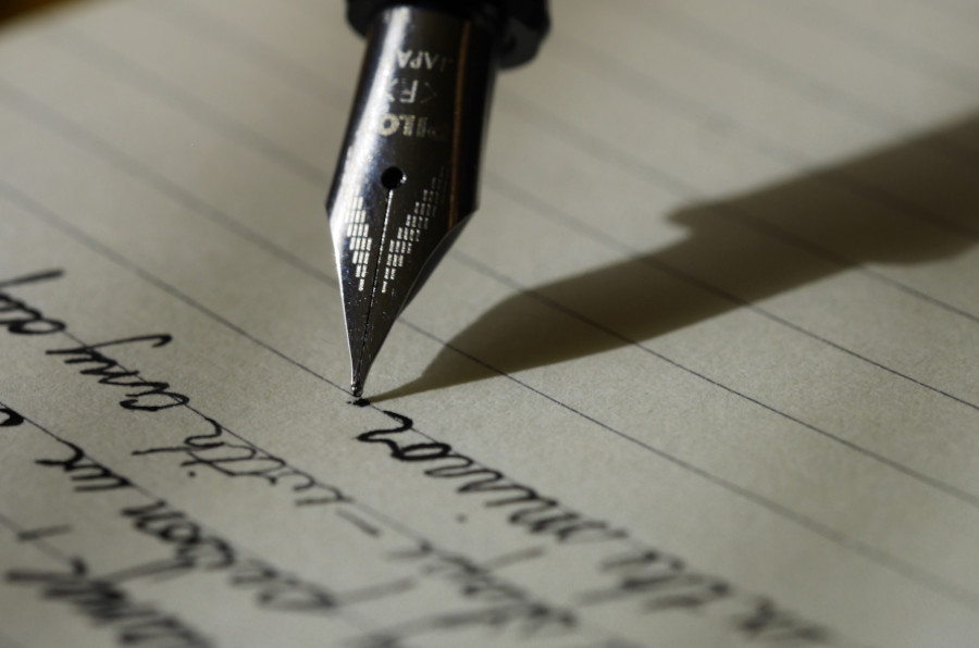 A pen is pointed at the word " write ".